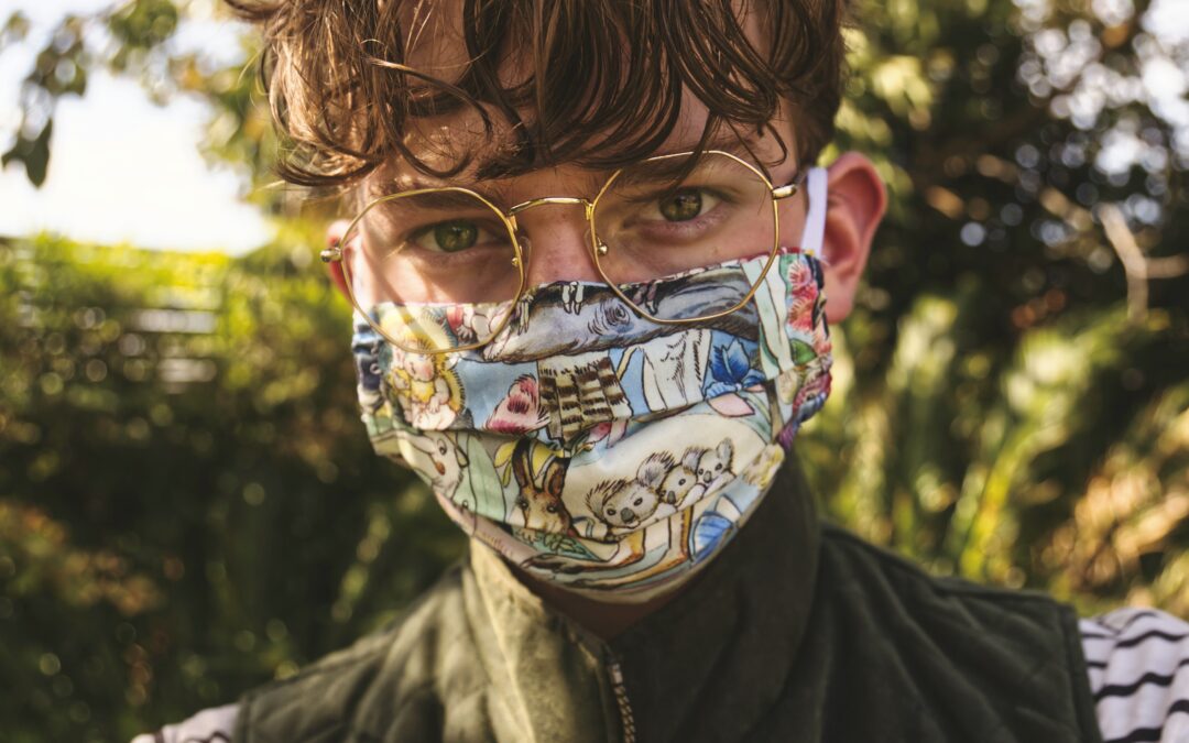 child wearing colorful covid mask